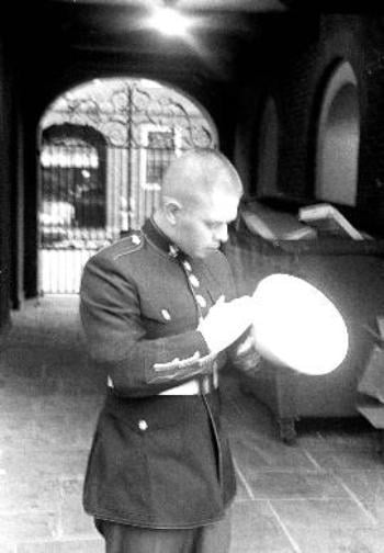 Marine Corps Reservist Lance Corporal RUBEN MARINELARENA ’02-’03 brushes off the brim of his dress blue hat outside Lowell House yesterday.