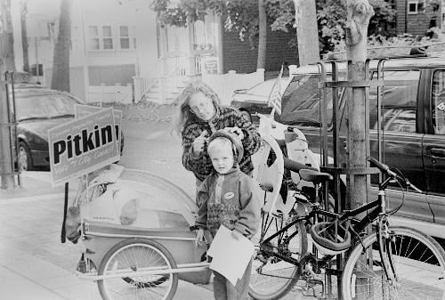 Two John Pitkin supporters campaign for the neighborhood activist who lies a few votes out of a council seat, yesterday.