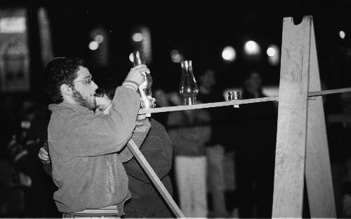 NOAM OSBAND, president of Harvard Friends of Chabad, lights a menorah in a ceremony in front of the Widener Library steps. Hanukkah began at sundown last night.