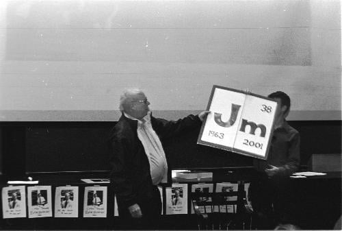 Retiring Chemistry senior lecturer JAMES E. DAVIS receives a jesting token of appreciation from students and teaching fellows yesterday after delivering his final lecture.