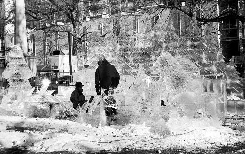 Artists put the finishing touches on “Circle of Life,” an ice sculpture depicting Alaskan wildlife. The sculpture on Boston Common was created for First Night, the city’s annual New Year’s Eve celebration.