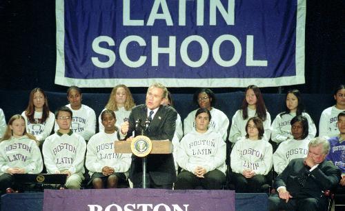 Senator EDWARD M. “TED” KENNEDY ’54-’56 (D-Mass.) looks on as PRESIDENT BUSH speaks at Boston Latin School yesterday after signing the “No Child Left Behind Act.”