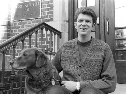 MATTHEW J. DeGREEFF ’89 sits outside his Greenough Hall residence with his Chesapeake Bay retriever BIX. DeGreeff will leave Cambridge after 17 years at Harvard, including nine as a first-year proctor.