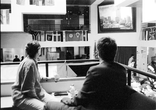 People gather in the Kennedy School of Government's ARCO Forum Sept. 11 to watch the day's events unfold, a scene repeated across campus that day. Later, the Kennedy School holds a series of discussions about the attacks