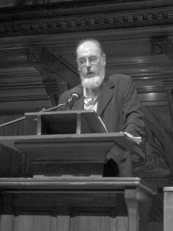 Poet EAMON GRENNAN gives a reading at a ceremony held in Sanders Theater yesterday to commemorate the 75th anniversary of the Grolier Poetry Book Shop.