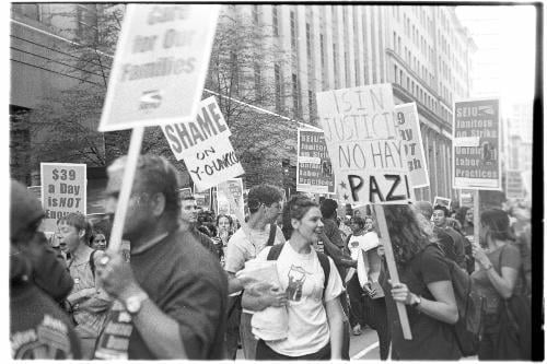 Students and janitors march through downtown Boston last night as 2,000 workers went on strike.