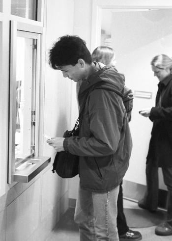 TIMOTHY Y. MARIANO ‘03 picks up his free ticket to the Harvard-Yale game at the Murr Center. This is the first year that the tickets are being offered free of charge to undergraduates.