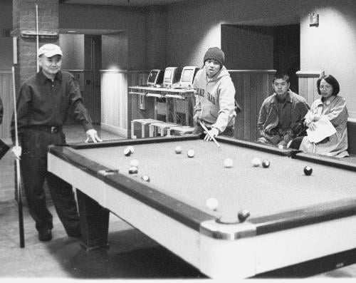 Wei-Jen Yuan ‘06 plays pool with his father, mother and brother in Loker Commons. Yuan’s parents were visiting for Freshmen Parents’ Weekend.