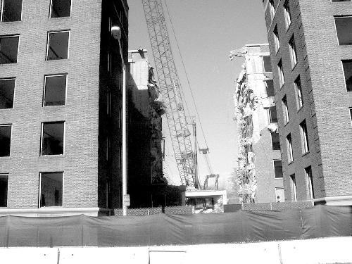 A wrecking ball swings into the middle of Coolidge Hall on Friday afternoon. In its place, Harvard will soon begin construction on the Center for Government and International Studies, the future home of the government department and related centers.
