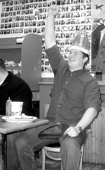  IAN D. WALKER ’03 celebrates his victory after eating six pounds of meat in the “Burger Pot” yesterday.