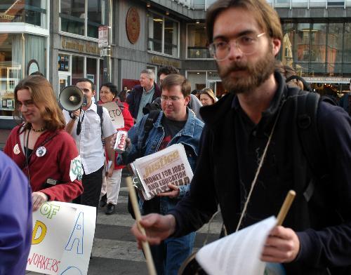 PAUL G. DEXTER ’04 (right) joins marchers from the Progressive Student Labor Movement and Harvard unions protesting the University’s labor practices in a “Walk of Shame” held yesterday.