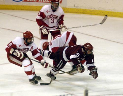 Freshman CHARLIE JOHNSON (19), who saw regular time with the second power play unit, is tripped up by Terrier stick work in NCAAs.