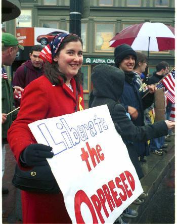 Despite freezing rain, Harvard Divinity School student BRONWEN C. MCSHEA ’02 rallies for patriotism Saturday along with a dozen other Harvard students in Harvard Square.