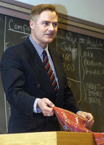 TOM PALMER, a senior fellow at the Cato Institute,  displays an Indian garment while talking about the benefits of free trade and globalization. 
