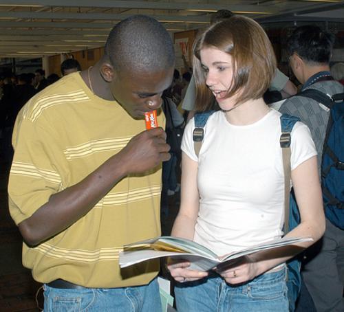 Pre-frosh AYODELE R. OSASONA (left) and KRISTEN J. LYNCH look over the Pre-frosh weekend schedule during the activities fair yesterday in the Science Center.
