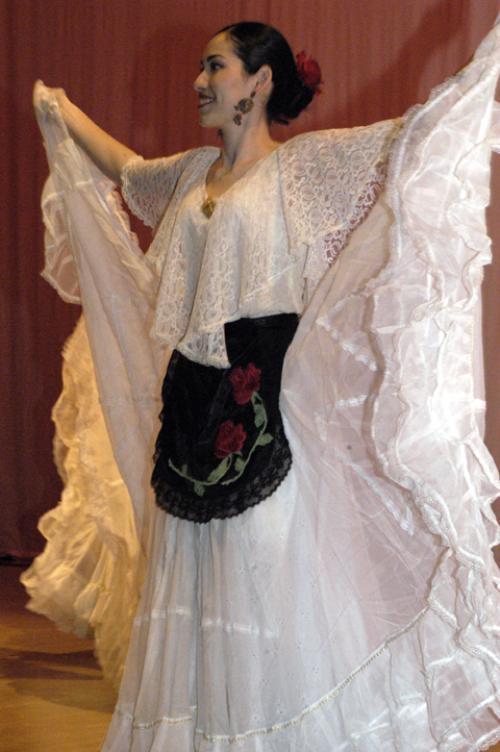 A student dances a traditional Latina dance during the first-ever Presencia Latina Friday night.