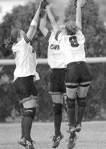 The Harvard softball team’s outfield displays team spirit during the Crimson’s 7-7 Ivy season this year.