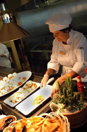 PAT DIZZURRO prepares a taco dish during the grand reopening of the Greenhouse at the Science Center yesterday.