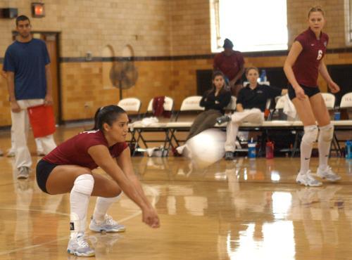 Senior outside hitter NATHALIE MILLER (left), shown in earlier action, had a double-double against San Diego State, but the Crimson still fell 3-0.