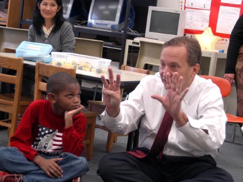 A first grader at the Jackson-Mann Elementary School in Allston, left, receives a lesson in counting from University President LAWRENCE H. SUMMERS yesterday when Summers served as principal for a day.