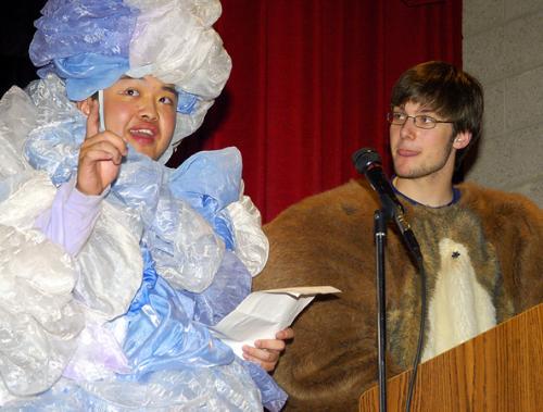 BO MENG ’06, left, and JOHN P. BLICKSTEAD ’06, sport costumes as they join fellow Hasty Pudding members in donating $11,000 to the Cambridge Public Schools yesterday. 