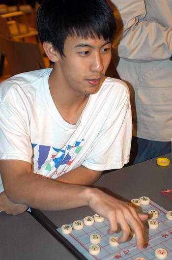 TERRY TAI ’05 makes a move at the first meeting of the Harvard Chinese Chess Club yesterday in Ticknor Lounge. In an e-mail sent to House open lists, founders called the club “new, energetic and fun!” 