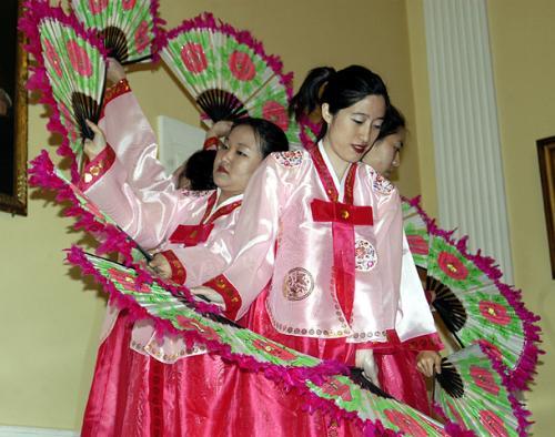 The Chunsa Dance Troupe performs a traditional Korean fan dance at the Cultural Extravaganza in Lowell Dining Hall Friday.