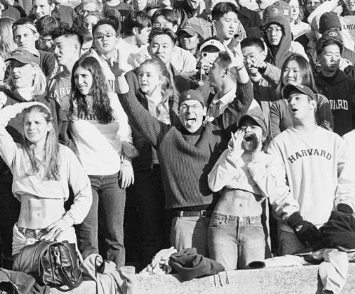 DOV FOX '04 (center, with arms raised) screams for joy as Harvard defeats Yale 35-23 at the Yale Bowl the last time The Game was played there in 2001. The two temas will face off tomorrow in New Haven.