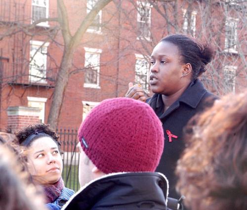 KUDZAI A. MAKOMVA ’06 of Zimbabwe speaks of the effects of AIDS in her homeland as AMANDA S. ALEXANDER ’04 looks on at a rally outside of the Science Center yesterday.