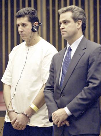 Geremias Cruz Ramos, left, was granted $1,000 bail for two counts of indecent assault and battery at a hearing at Middlesex District Court Tuesday. Ramos, seen here with attorney Carlos Dominguez, is a janitor at the Holyoke Center and is accused of 