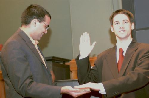 Outgoing Undergraduate Council President Rohit Chopra ’04 swears in incoming President Matt W. Mahan ’05, yesterday. Mahan and incoming Vice President Michael R. Blickstead ’05 pledged to focus on both improvements in student life.