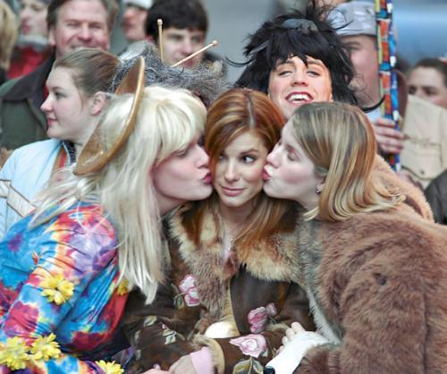 Actress Sandra Bullock, the Hasty Pudding Woman of the Year, receives kisses from members of the Hasty Pudding Theatricals, in a parade down Mass. Ave. yesterday.