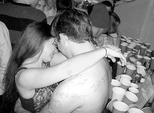 Two students canoodle in the Pforzheimer House bell tower suite at Saturday night's AEPi party, which offered its late-night attendees ample alcohol and a crowded dance floor.