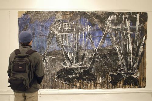 John A. LaRue ’07 observes a work by Tsitsi I. Gora ’05 during the Umoya Art show, which opened in the Adams Art Space last night in celebration of Africa Week. 