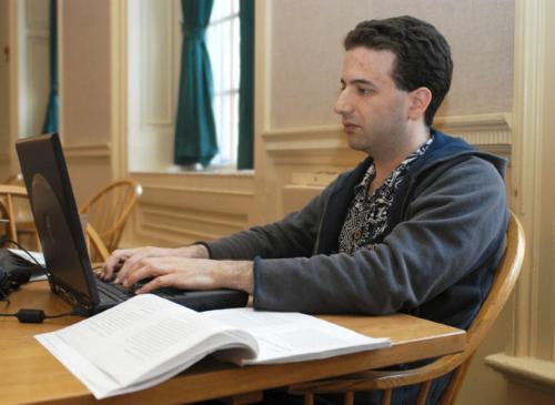 Leverett House resident tutor Stuart E. Schechter uses wireless Internet access on his laptop computer in Leverett Dining Hall.