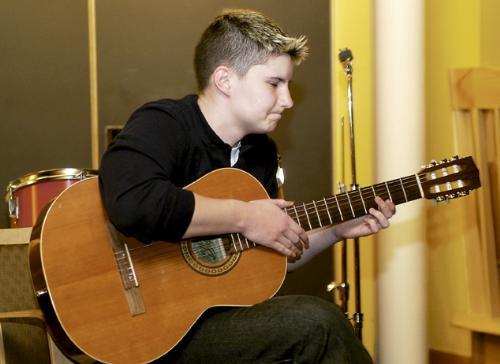 Mary K. Eagle ’06 strums her guitar at the kickoff of Gaypril 2004, a series of activities and parties organized by the Harvard BGLTSA for the month of April. The night featured musical guests, dramatic readings and storytelling.