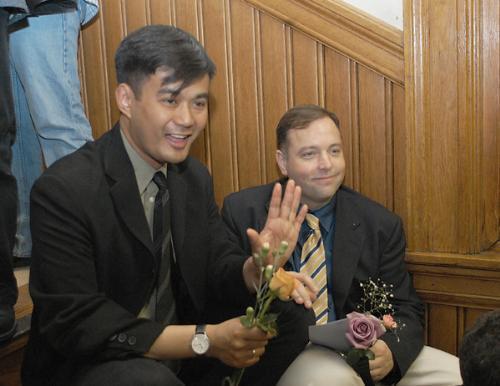 Bren Bataclan, left, waits with his partner Bob L. Parlin '85 for a marriage license at Cambridge City Hall.