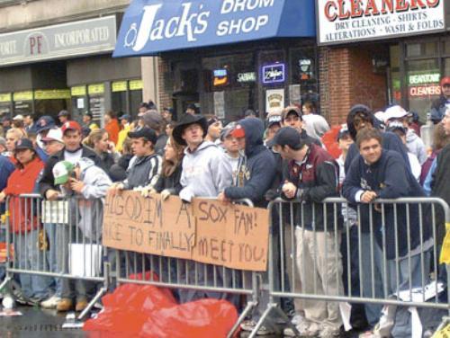 Braving a rainy, cold Saturday morning, Red Sox fans lined the streets of downtown Boston and held up signs celebrating their team’s first World Series victory in 86 years during the Sox’ victory parade.