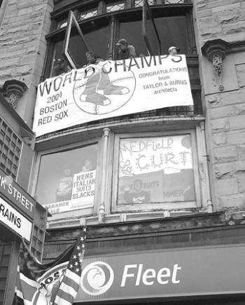 Businesses along the parade route hung signs to help commemorate the first Red Sox World Series victory since 1918.  
