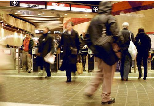 Travelers walk through the Harvard Square subway station yesterday afternoon. Crime across all MBTA stations declined by 17 percent this year, according to a report released last week.