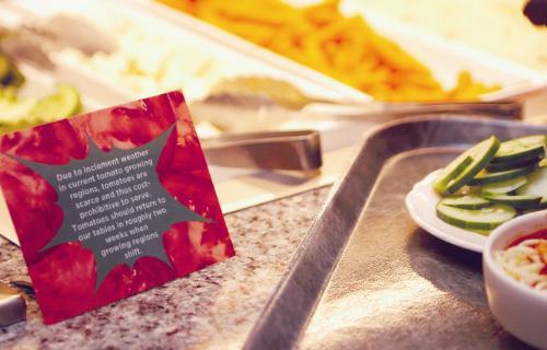 A card at the Quincy House Dining Hall’s salad bar explains the recent lack of fresh tomatoes.