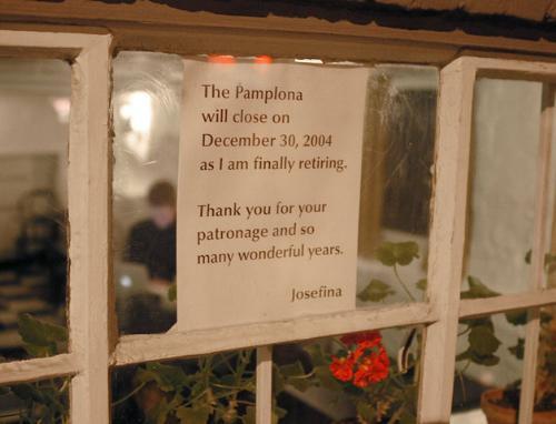 A sign in the window of Cafe Pamplona on Bow Street informs patrons that the owner will be retiring and closing the cafe at the end of the year.