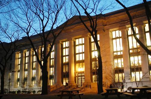 Harvard Law School’s Langdell Library, lit up at night, is the subject of a legal dispute between Richard Max Strahan and the University.

