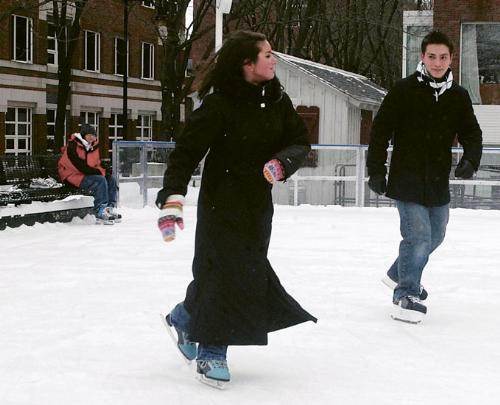 Two Harvard students try out the new ice skating rink by The Charles Hotel yesterday. Temperatures in the Square dipped into the single digits last night, but the cold snap is expected to subside later in the week.