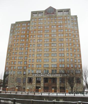 The 15-story Doubletree Guest Suites Hotel in Allston sits across the Charles near the entrance to the Mass. Turnpike.