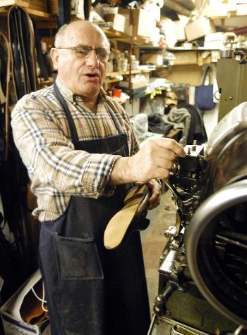 Harvard Square cobbler Christos Soillis works in his shop, Felix's Shoe Repair, yesterday afternoon.