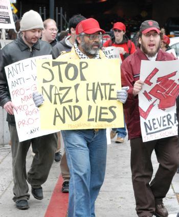 Several hundred protesters confronted members of the white supremacist group White Revolution outside Faneuil Hall in Boston yesterday.