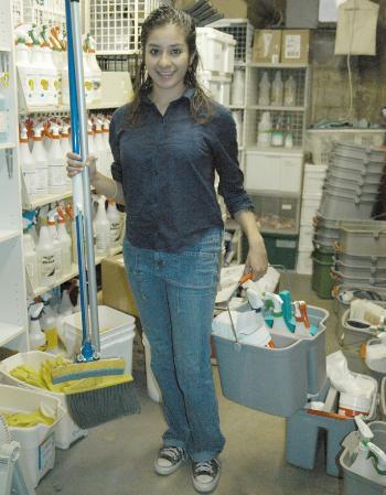 Dorm crew worker Rosa E. Beltran ’08 picks up her supplies in the dorm crew store room in Straus basement.