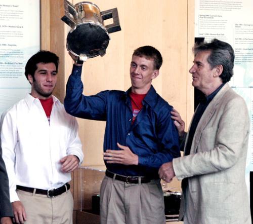 Paul F. Gilligan III ’05, right, hoists the Straus Cup with his roommate and intramural co-secretary Stephen J. Robbins ’05 after Eliot’s victory on May 18, 2004.