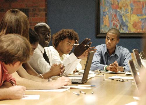 Kwame Owusu-Kesse ‘06, inter-campus coordinator for Students Taking on Poverty (STOP), leads a discussion bringing together 25 students at the Institute at Politics on Wednesday with the special goal of helping hurricane victims.  See story, page A6.